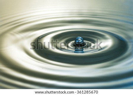 Dripping water. Liquid drops. splashing. black and white background. macro view, toned photo. soft focus