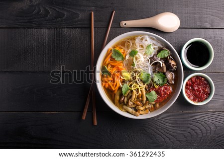 Traditional chinese soup with noodles, mushrooms and vegetables Royalty-Free Stock Photo #361292435