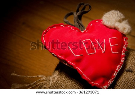 Love red gingham heart hanging on Ash wooden texture background, Valentine's day message card