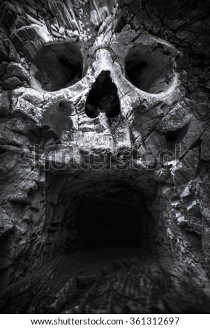 cave in the mountains, a human skull. fantastic picture