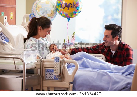 Family With New Born Baby In Post Natal Hospital Department Royalty-Free Stock Photo #361324427