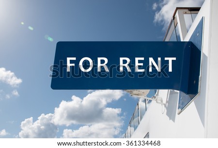 FOR RENT sign on white modern wall.
