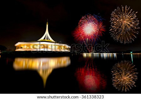 Beautiful building with reflex on the lagoon againt black sky and fireworks background in public park, Suanluang Rama 9, Thailand.