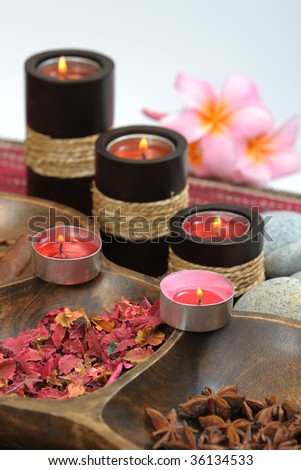 spa candle and plumeria with stone