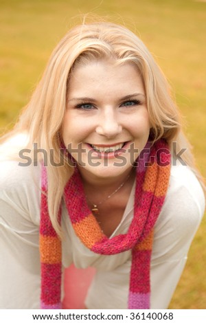 Closeup picture of a young funny friendly girl having fun on the orange lawn