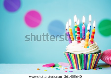 Colorful birthday cupcake with single candle