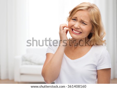 unhappy woman suffering from face inch Royalty-Free Stock Photo #361408160