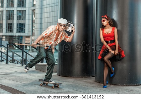 Old grandfather rushes on a skateboard. He had a stick in his hand for the elderly. Royalty-Free Stock Photo #361413152