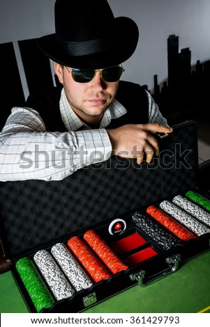Diller with a suitcase of chips. Professional poker player Royalty-Free Stock Photo #361429793