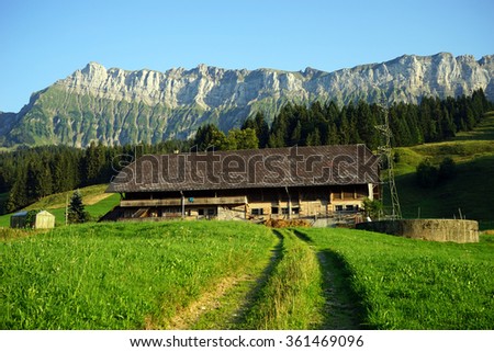 Track an the field and wooden shed in rural area, Switzerland