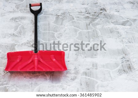 Red plastic shovel for snow removal. Winter is coming. Royalty-Free Stock Photo #361485902