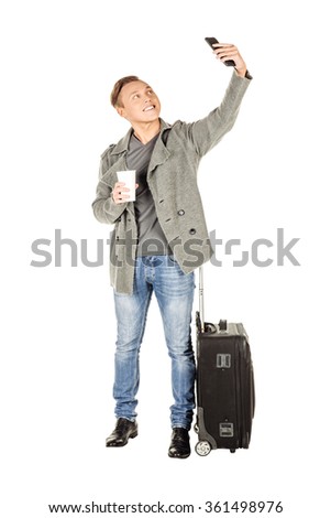 attractive tourist taking selfie photo with mobile on white background