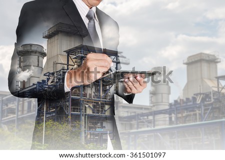 Double exposure of businessman working with tablet and  Electric Generating Factory, Power Reactor as energy, communication and technology concept. Royalty-Free Stock Photo #361501097