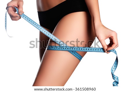 Woman measuring perfect shape of beautiful hips. Healthy lifestyles concept. Woman body part is being measured. Spa beauty part of body Healthy lifestyle,diet and fitness. Perfect waist, butt and legs