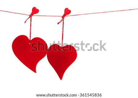 Two red valentine hearts hanging from a red string line isolated on white background 