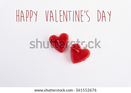 two heart red candle isolated on white background, happy valentines day text, greeting card concept