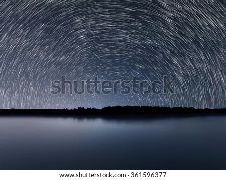 Star Trails, Beautiful Blue Night reflection.Clear night sky
Star trails over the river