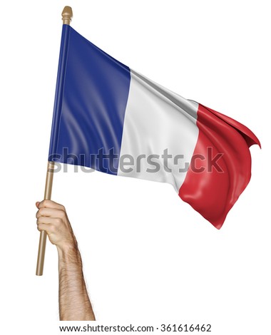 Hand proudly waving the national flag of France