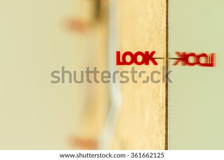 look word pin on cork board with reflection on mirror
