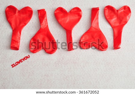 Valentine's Day. Red heart shape balloons isolated against a white background with I love you in text 