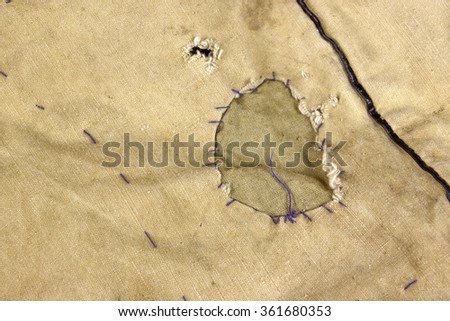 Weathered Military Army  Khaki Camouflage Fabric With Patch, Background Texture, Close Up, Top View