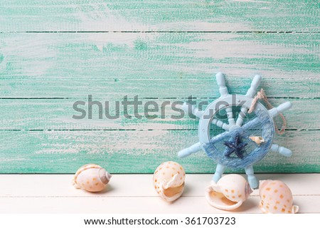 Decorative helm and marine items on turquoise wooden background.  Selective focus. Place for text.
