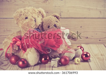 two teddy bears with rose on wood background, love concept for valentines day.vintage filter effect on photo