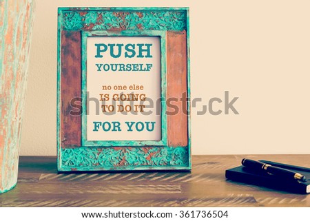 Retro effect and toned image of a vintage photo frame next to fountain pen and notebook . Motivational quote written with typewriter font PUSH YOURSELF NO ONE ELSE IS GOING TO DO IT FOR YOU