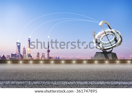 empty asphalt road and communication within modern buildings in blue sky at dawn