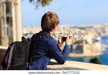 tourist taking photo on mobile phone in Malta
