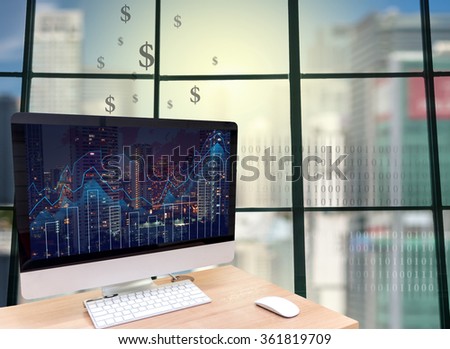 the computer on the wood table in front of the glass window over the blurred photo of cityscape background