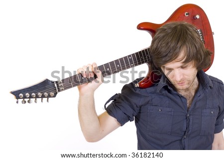 closeup picture of a guitarist with his guitar on shoulder