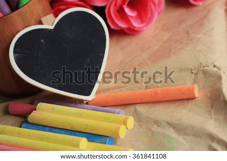 Colorful chalk with black heart