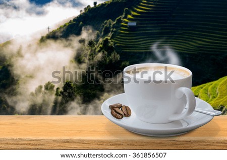 Coffee cup on the table with a natural backdrop.