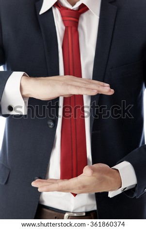 close-up portrait of a handsome young man in a suit gestures on a white background studio