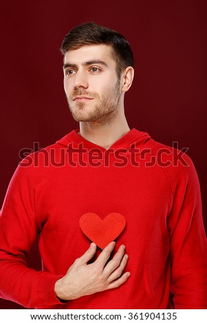 cute guy boy with a red heart in the hands