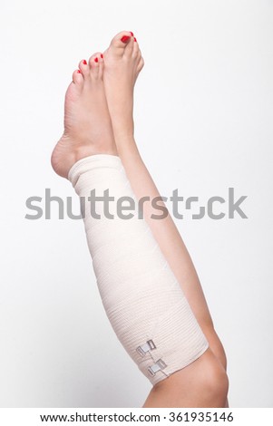 ankle woman on a white background dragged elastic bandage.