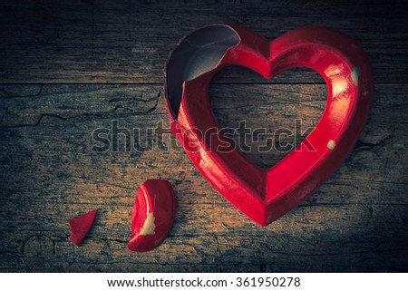 Valentine broken heart on a vintage wooden background