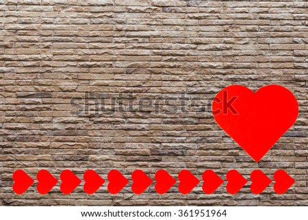 Red heart shaped on brick wall background. Symbol of love on brick wall.