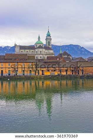 Waterfront with St Ursus Cathedral of Solothurn. Solothurn is the capital of Solothurn canton in Switzerland. It is located on the banks of Aare and on the foot of Weissenstein Jura mountains