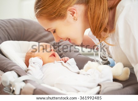 happy family. mother plays and laughs with her newborn baby