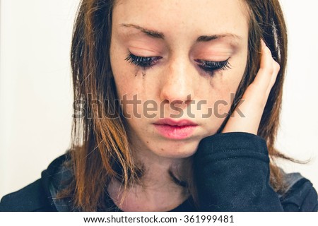 Closeup of a Young girl,that is crying isolated on a white background - people and moods concept Royalty-Free Stock Photo #361999481