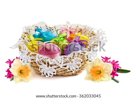 Easter eggs in the basket, narcissus and hyacinth on white background
