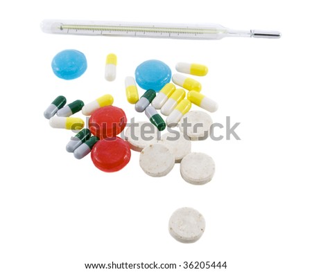 Many different color tablets, pills and thermometer isolated over white background