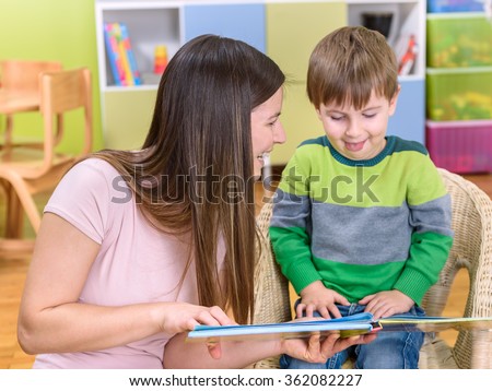Happy Kid and Mother Reading Picture Book