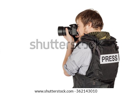 male press photographer wears a protective vest and takes photos with a professional camera
