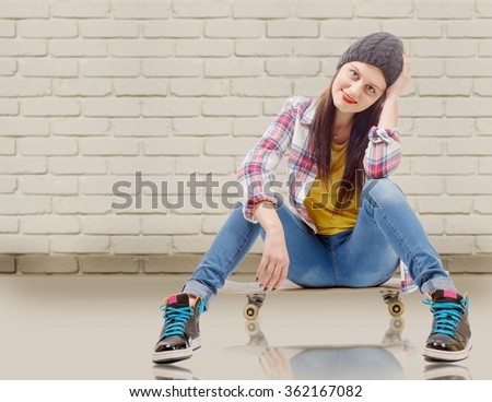 a beautiful young woman posing with a skateboard, seat on skate