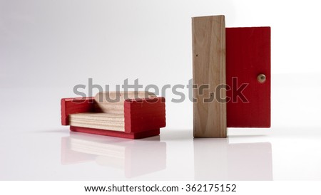 Wooden red door entrance and sofa. Isolated on white background. Slightly de-focused and close-up shot. Copy space.