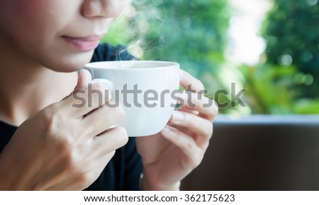 Working women are drinking hot coffee from a white cup. Royalty-Free Stock Photo #362175623
