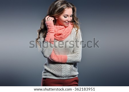 Beautiful natural young smiling blonde woman wearing knitted sweater and gloves. Fall and winter fashion concept.